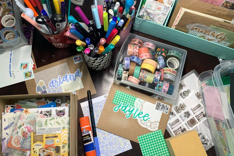 Melody Xus workspace is covered in pens, tape, stationary and more which she artfully utilizes to create her beautiful letters. (Melody Xu)