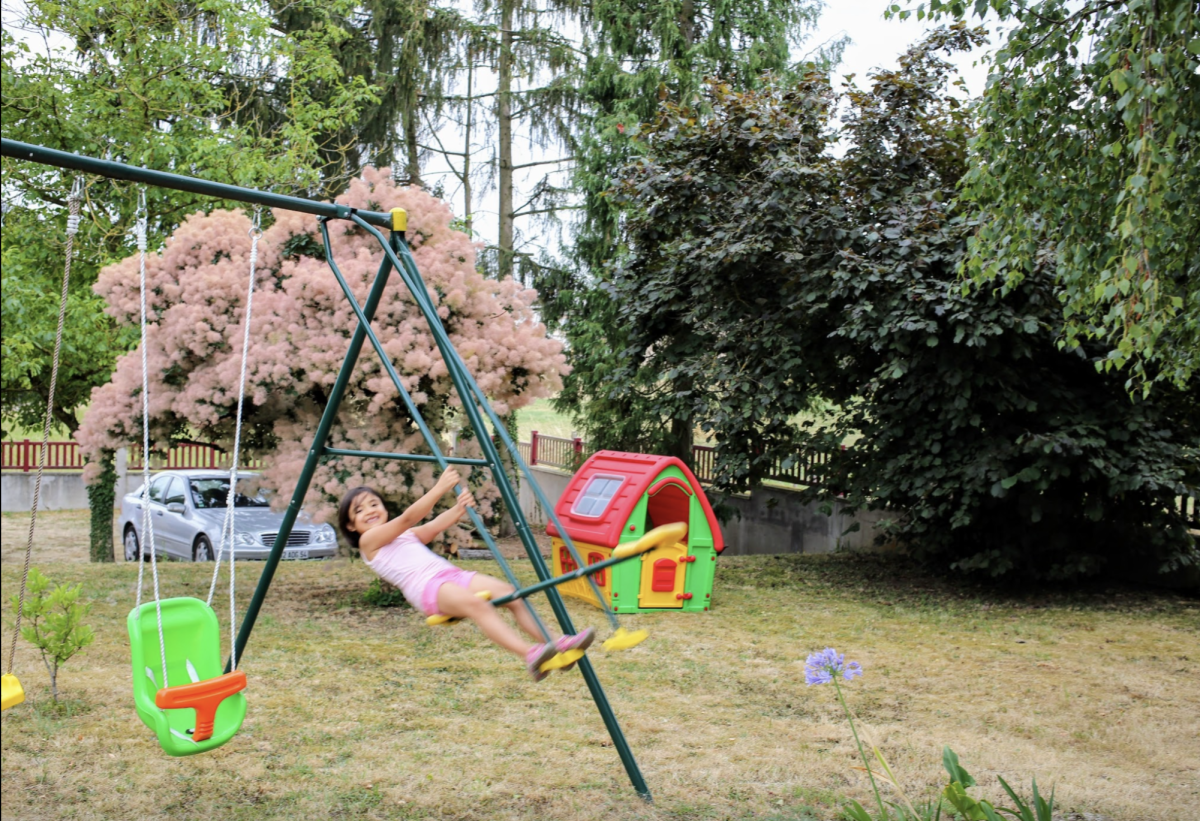 Paly junior Zoe Ferring on grandparents' swing, photo by Charles Ferring, used with permission, taken in 2015